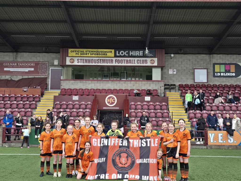 Gleniffer Thistle Girls teams holding team flag