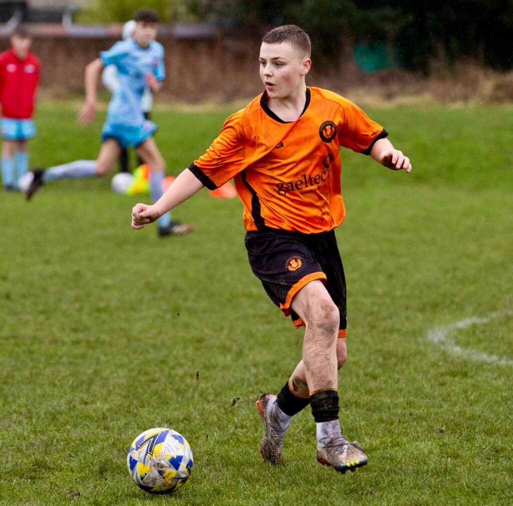 Boys team player with ball in possession