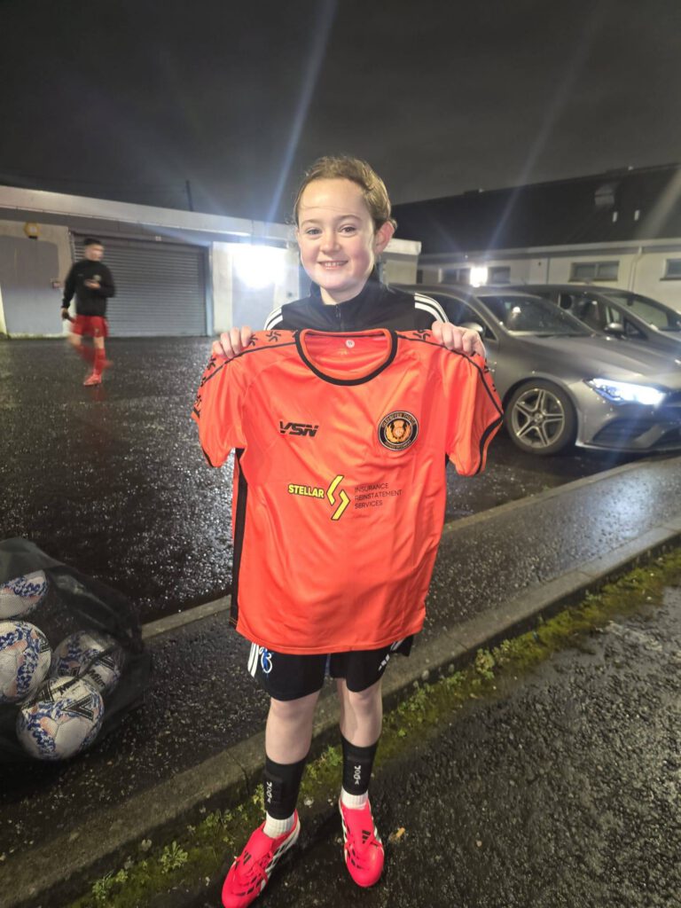 Girls team member holding their shirt